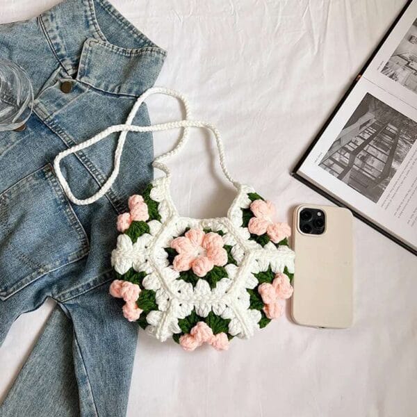 Handmade crescent crochet crossbody bag with soft texture and delicate floral style